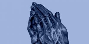 Sculpture of hands folded in prayer. The Serenity Prayer