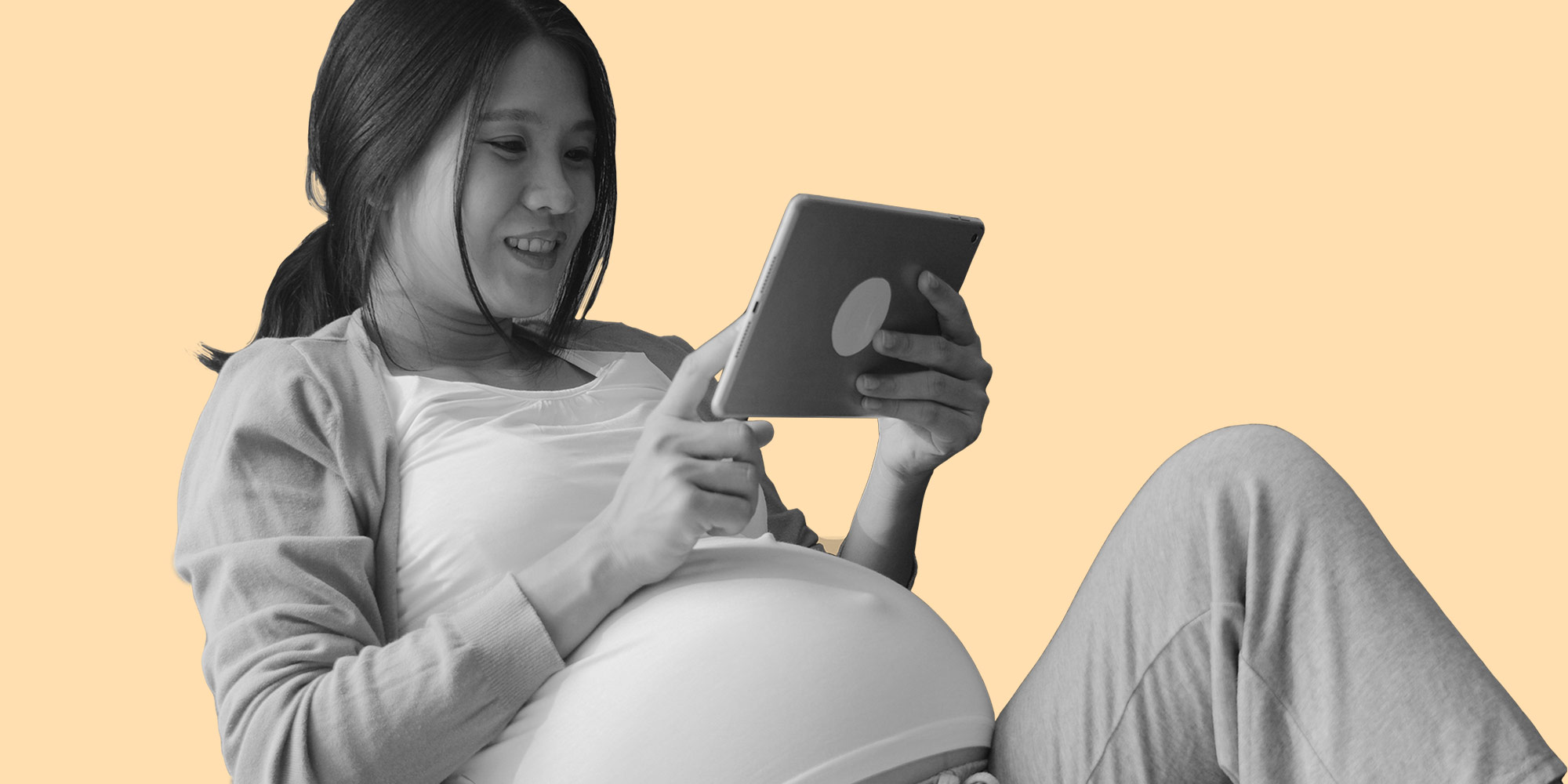 Pregnant woman reading on a tablet. Can you take naltrexone during pregnancy?
